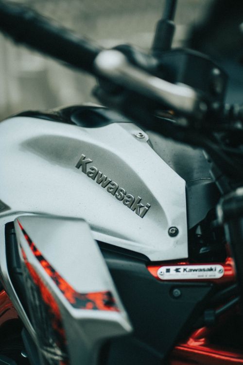 Free Detailed close-up of a Kawasaki motorcycle's body design, showcasing polish and branding. Stock Photo