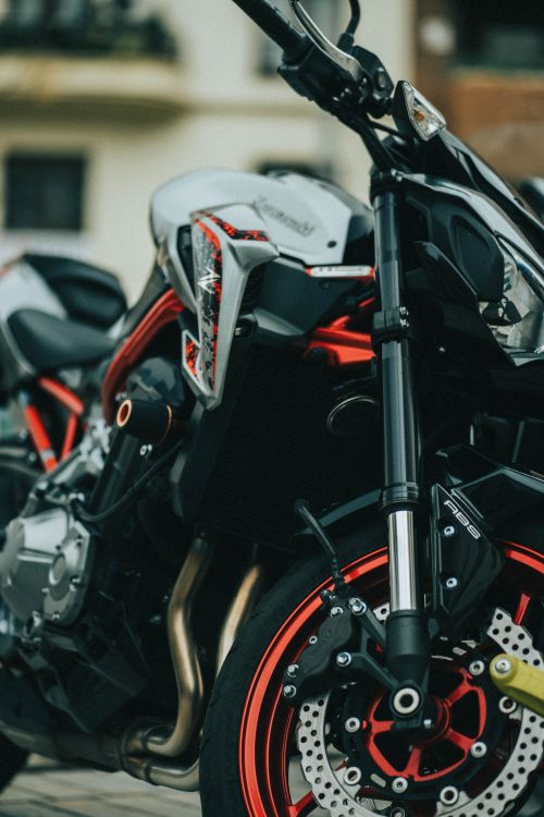 Free Detailed close-up of a parked sports motorcycle highlighting its sleek design and vibrant colors. Stock Photo