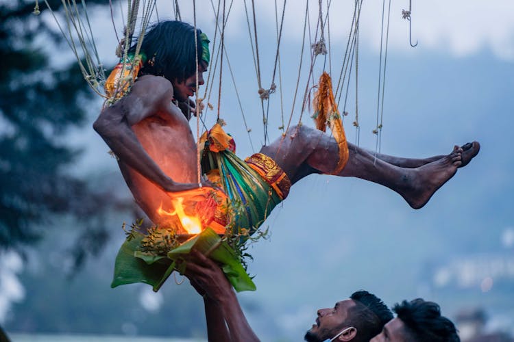 A Man Hanging On Hooks