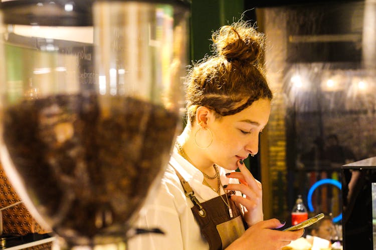 Barista Using Her Phone