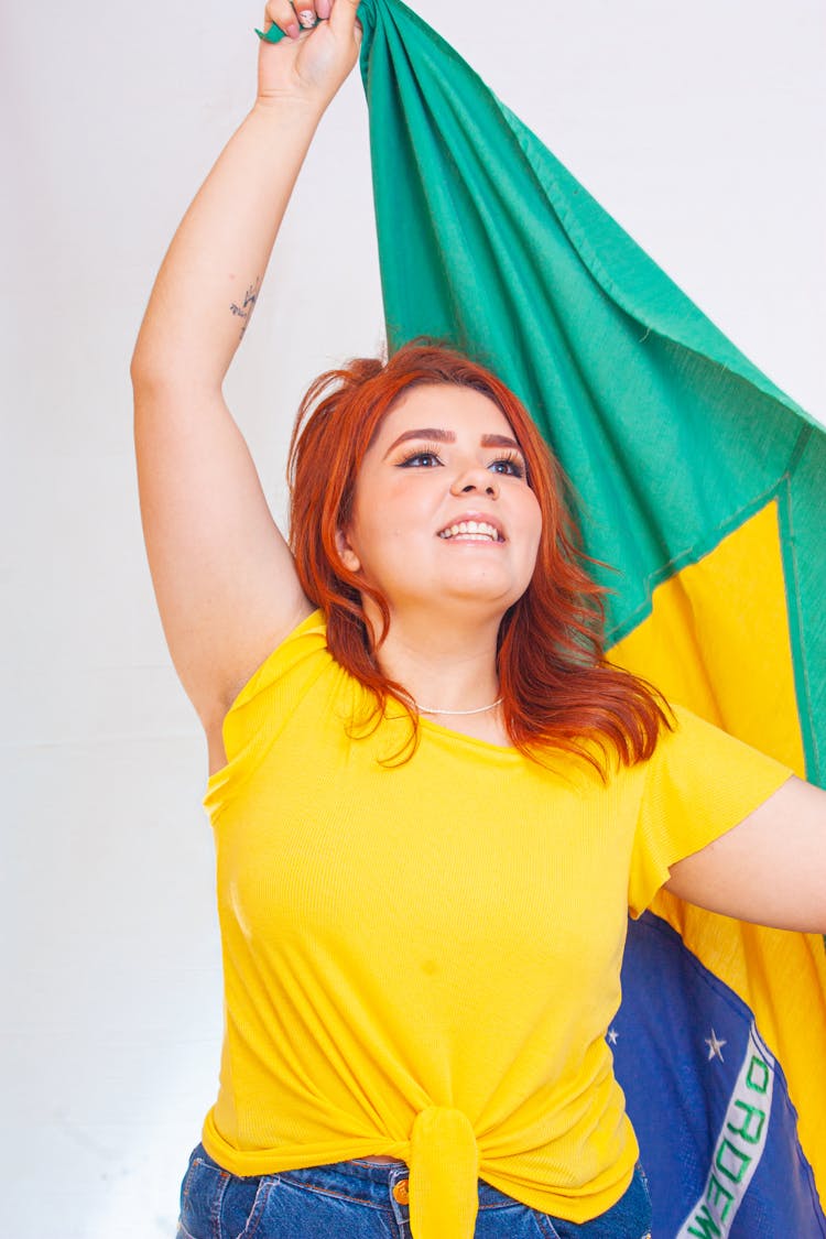 Portrait Of Woman Holding Brazilian Flag