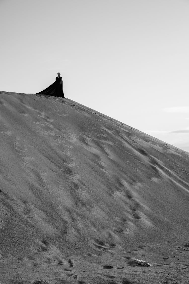 Woman In Long Dress On Top Of Sand Hill