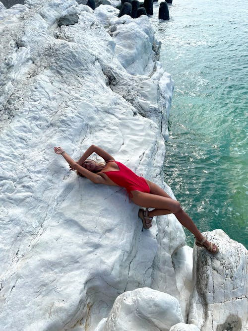 Woman Posing on Rocks in Swimsuit