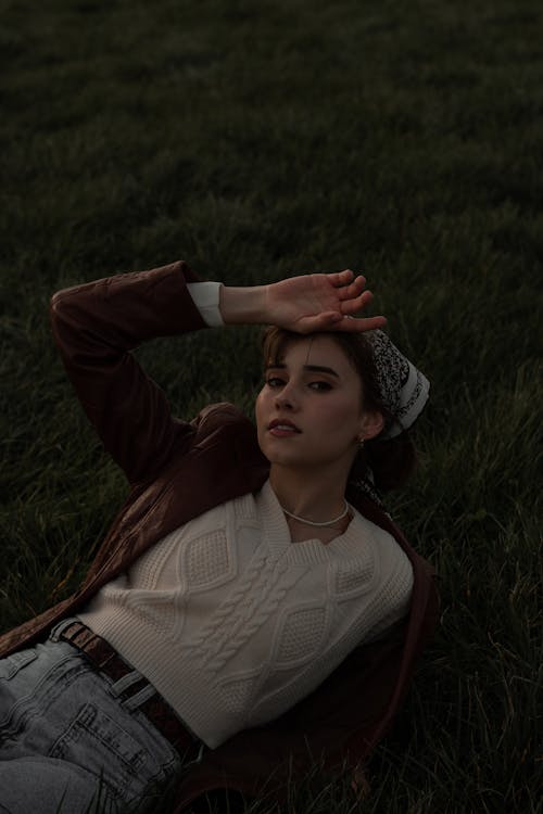 Woman in Leather Jacket Lying on Grass