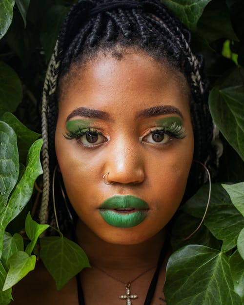Woman with Green Makeup Posing