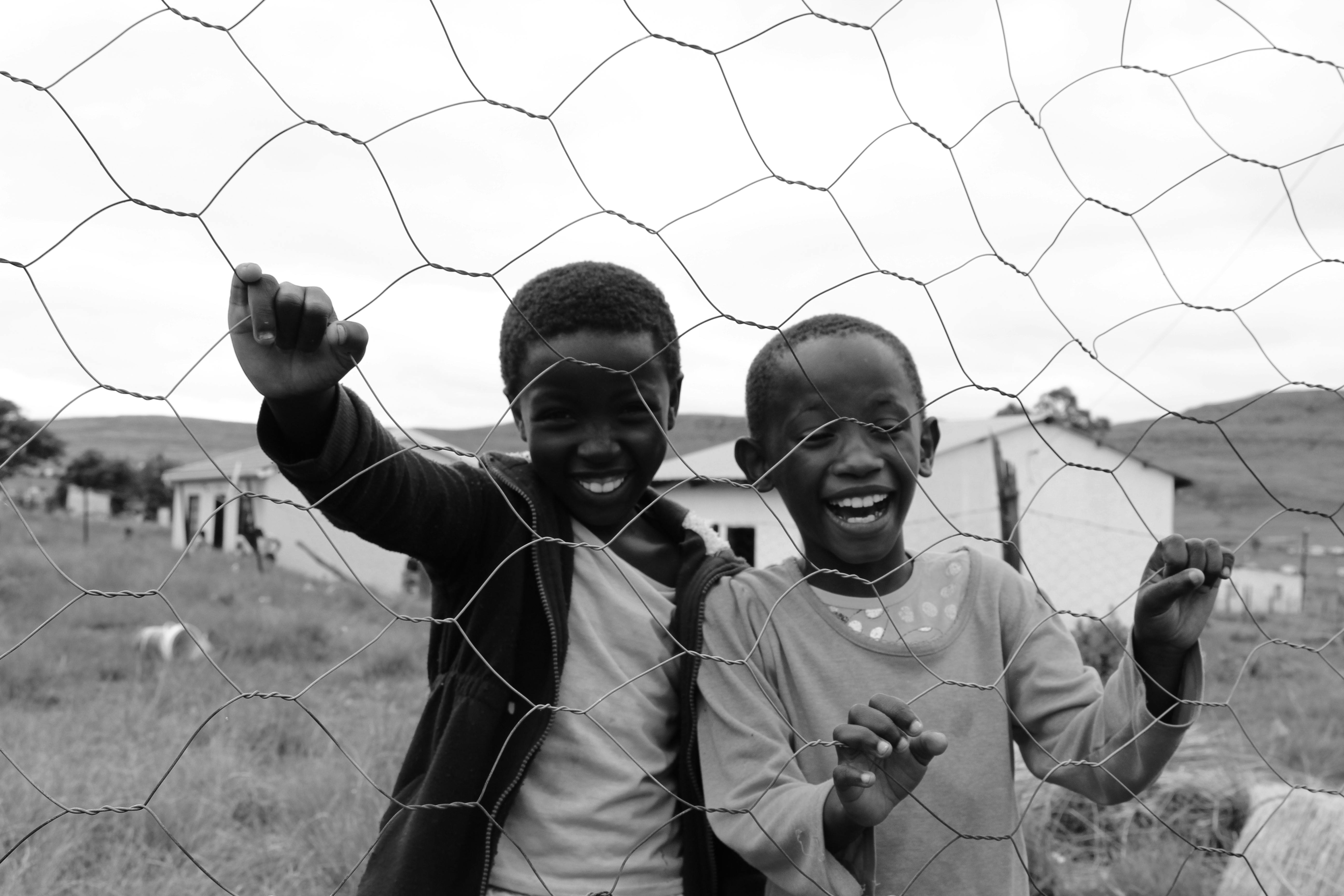 kids behind a chain link fence