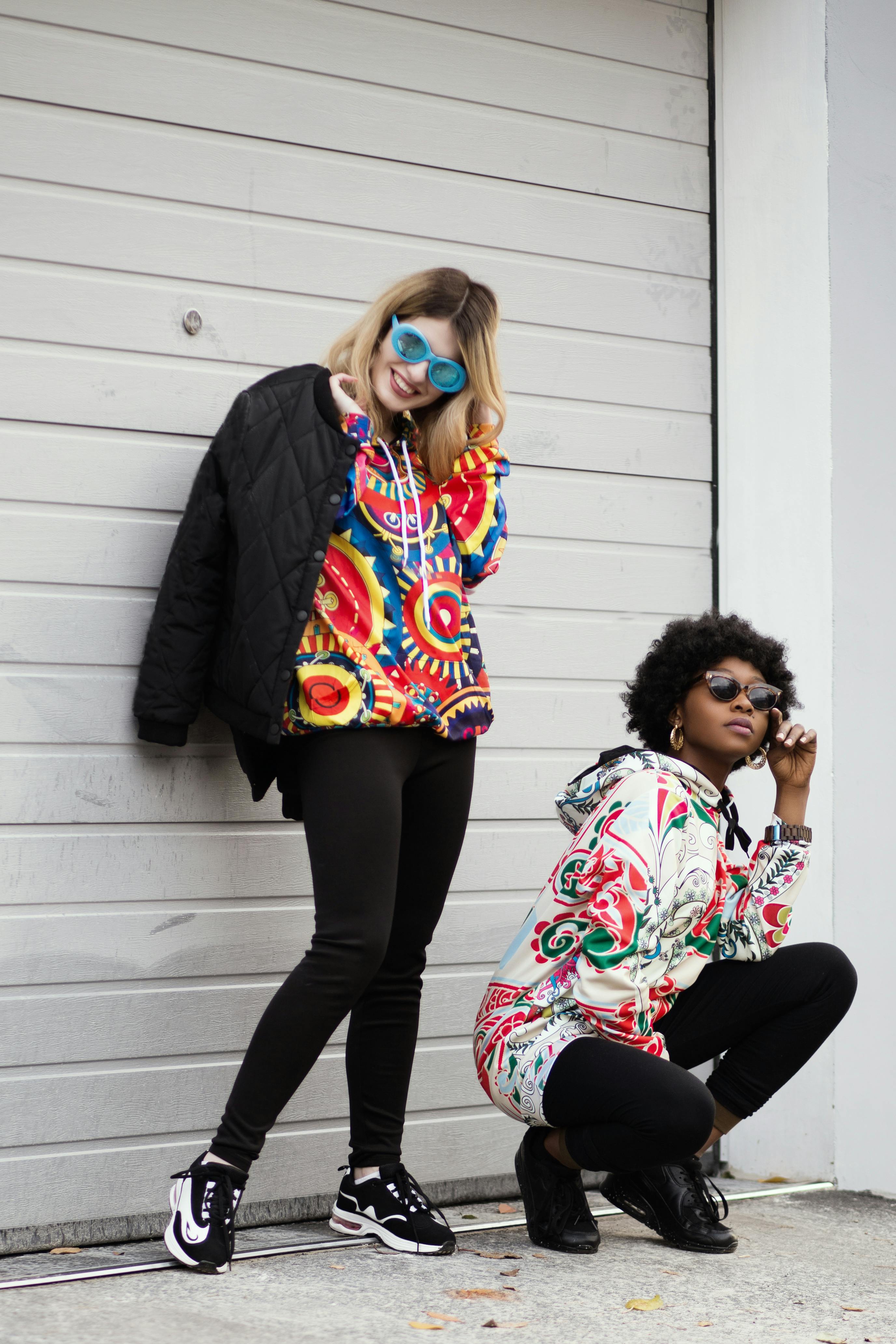 women wearing multicolored pullover hoodie and black jacket