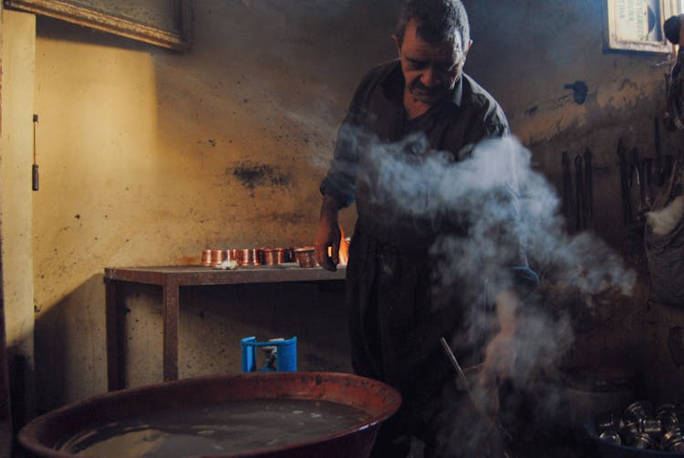 A Man Standing In A Kitchen