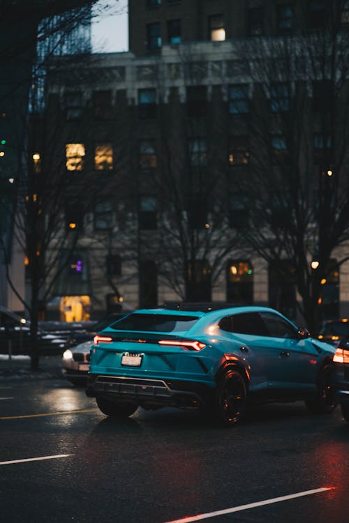 Back View of a Blue SUV on the Road 