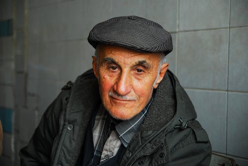 Free An Elderly Man Wearing a Flat Cap Stock Photo