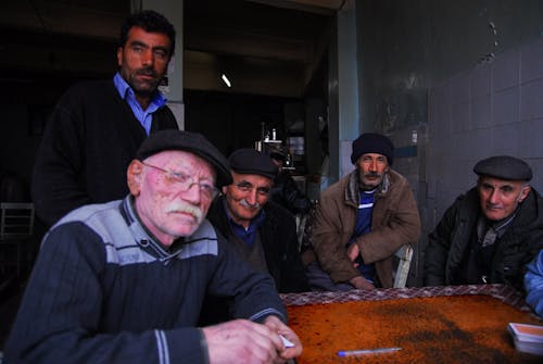 Men Sitting at Table and Playing Cards