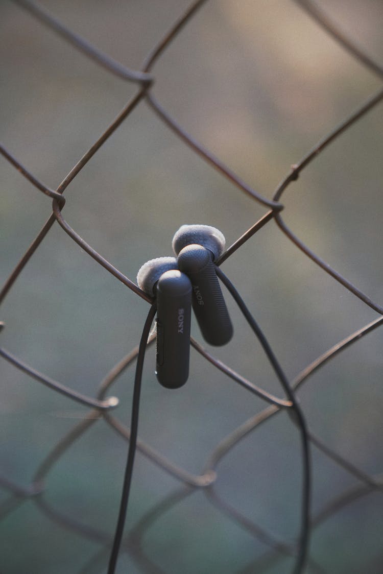 Earphones On Fence Net