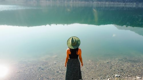 Free A woman stands at the shore of a serene lake in Puebla, Mexico, enjoying nature and tranquility. Stock Photo