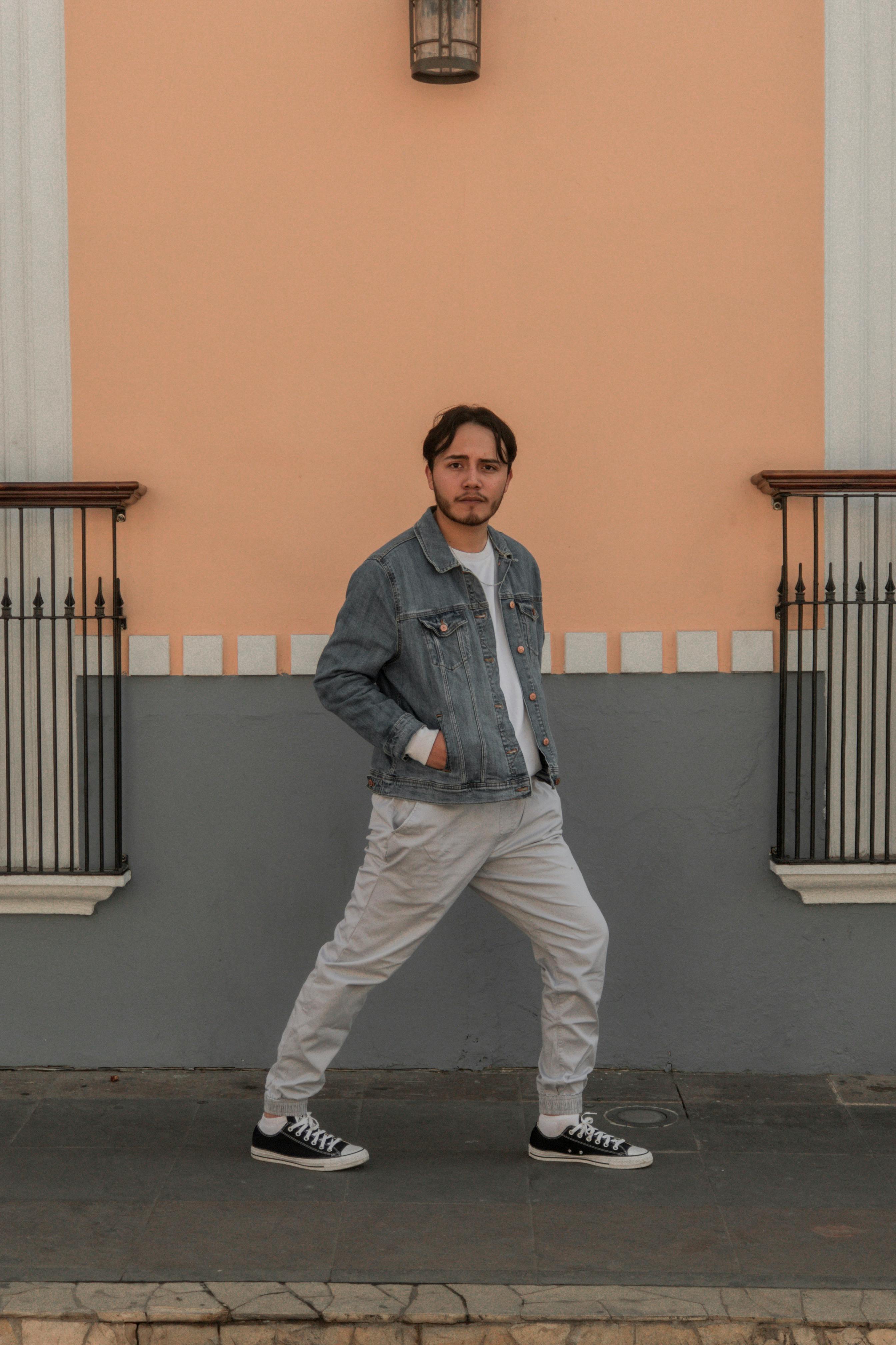 Man In Red And Black Zipup Jacket And Black Pants With Black Hat