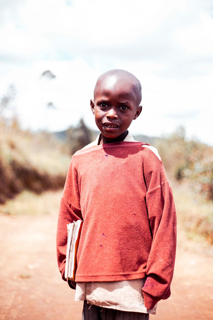 Boy In Red Sweater Holding Papers