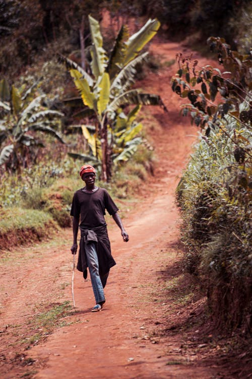 Man Walking on Dirt Road