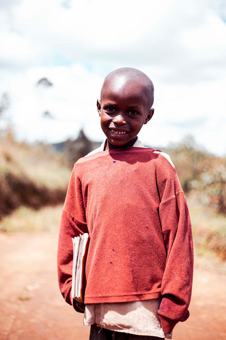 Smiling Little Boy Holding Notebooks