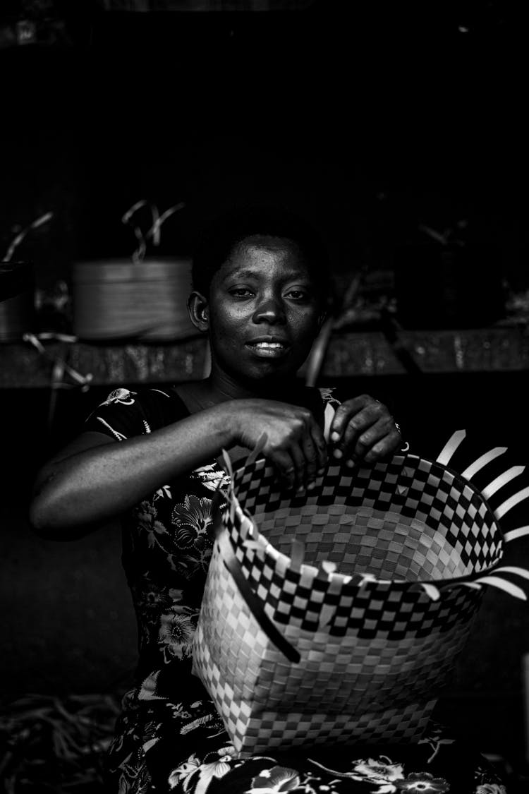 Grayscale Photo Of A Woman Weaving A Basket 