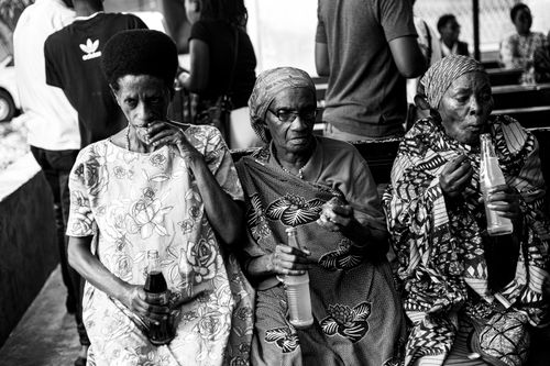 Free Three elderly women sitting and drinking soda in a candid black and white photograph. Stock Photo
