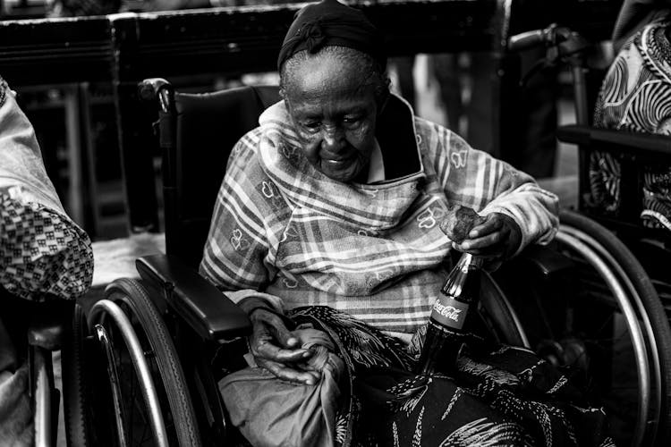 An Elderly Woman In A Wheelchair