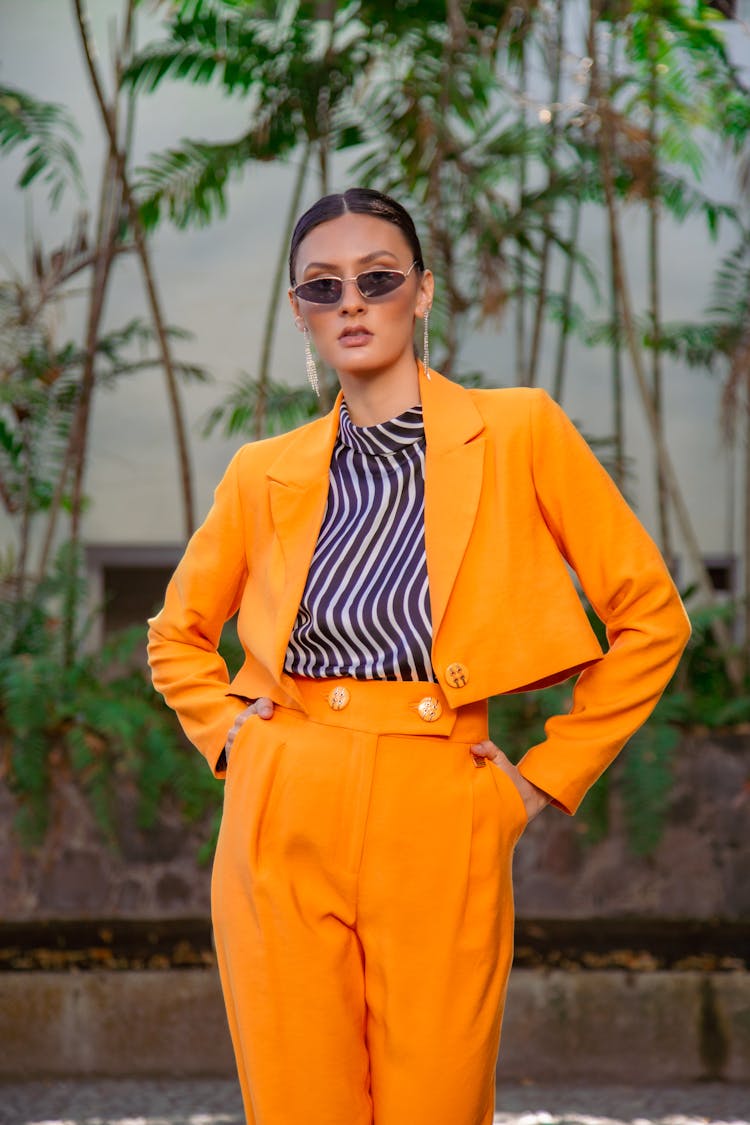 Smoothly Combed Brunette Woman Presenting Orange Outfit