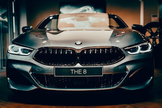 Front view of a shiny luxury BMW car with distinctive headlights and emblem.