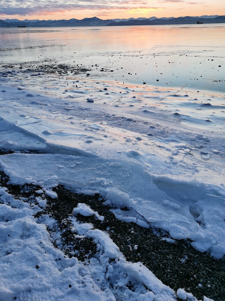 Snow On Shore At Sunset