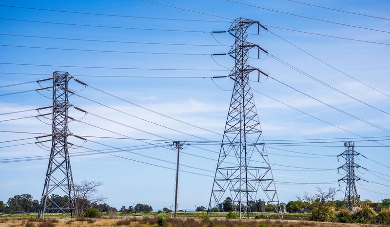 High-voltage electric pylons in a field
