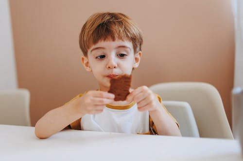 A Young Boy Looking his Food