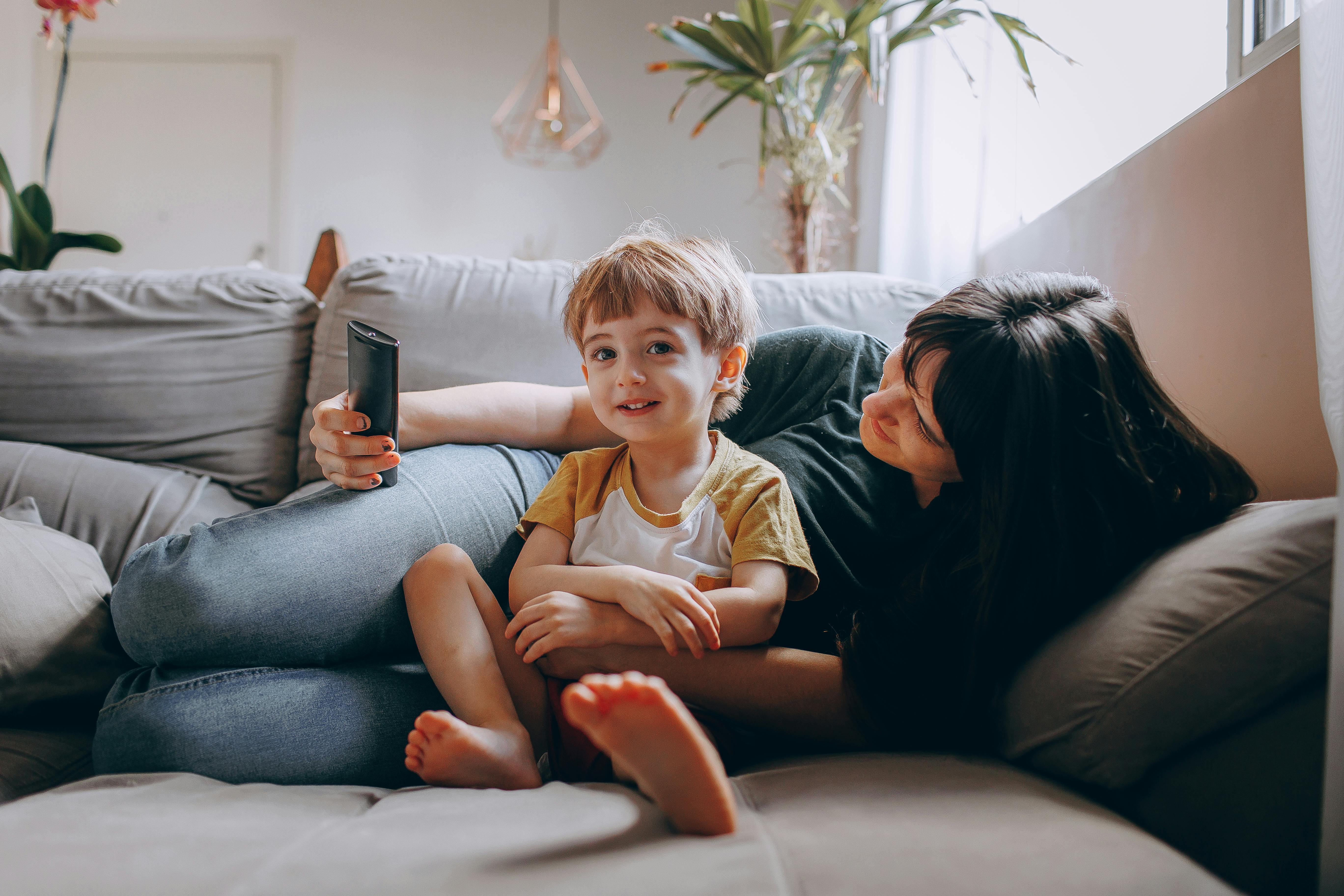 mother lying on couch with her son