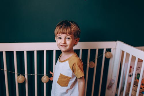 Little Boy Standing in His Crib