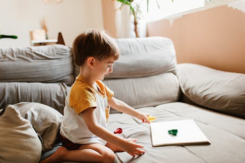 Little Boy Playing and Sitting on Couch