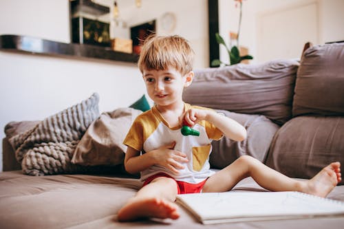 Smiling Boy Sitting on Couch