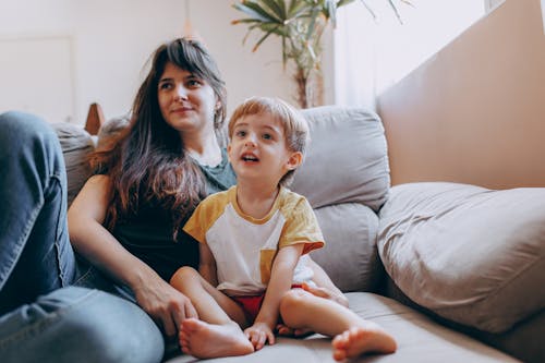 Mother with Her Little Son on a Couch 