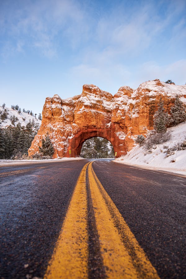 Brown Rock Formation on Gray Asphalt Road