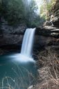 Water Falls Between Brown Rocky Mountain