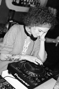 Woman in Long Sleeve Shirt Playing Dj Controller