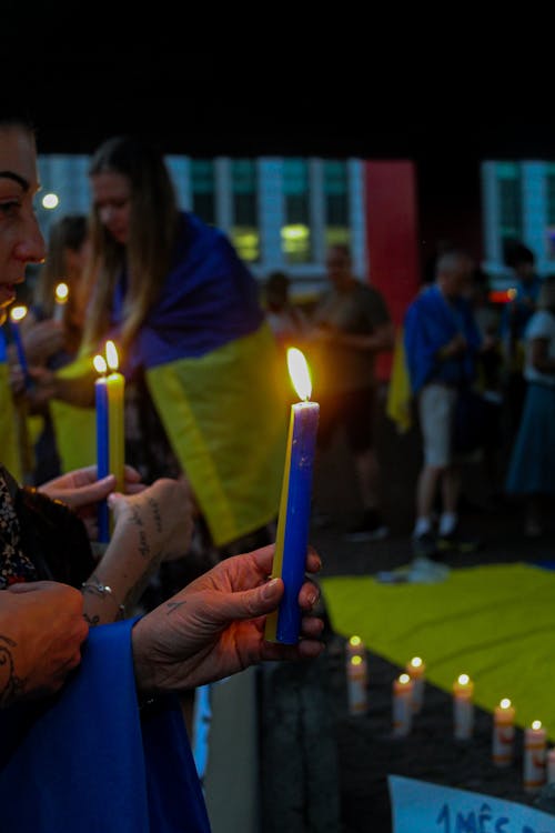 People with Ukrainian Flags and Wax Candles