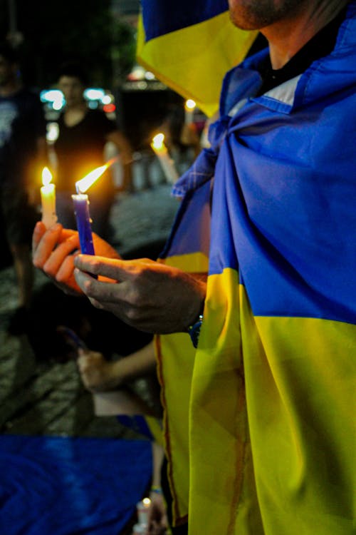 A Person Holding Lighted Candles