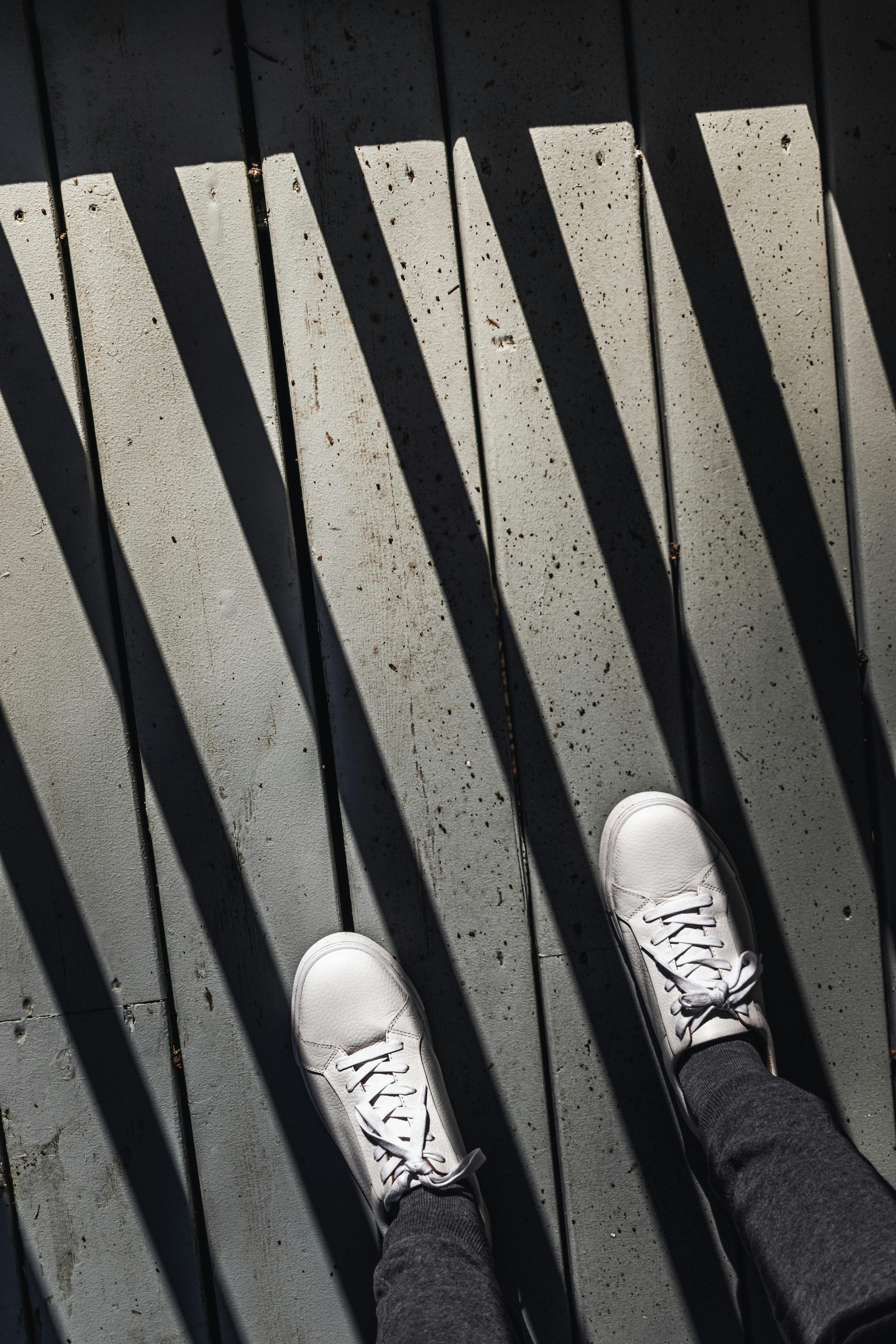 person wearing white sneakers