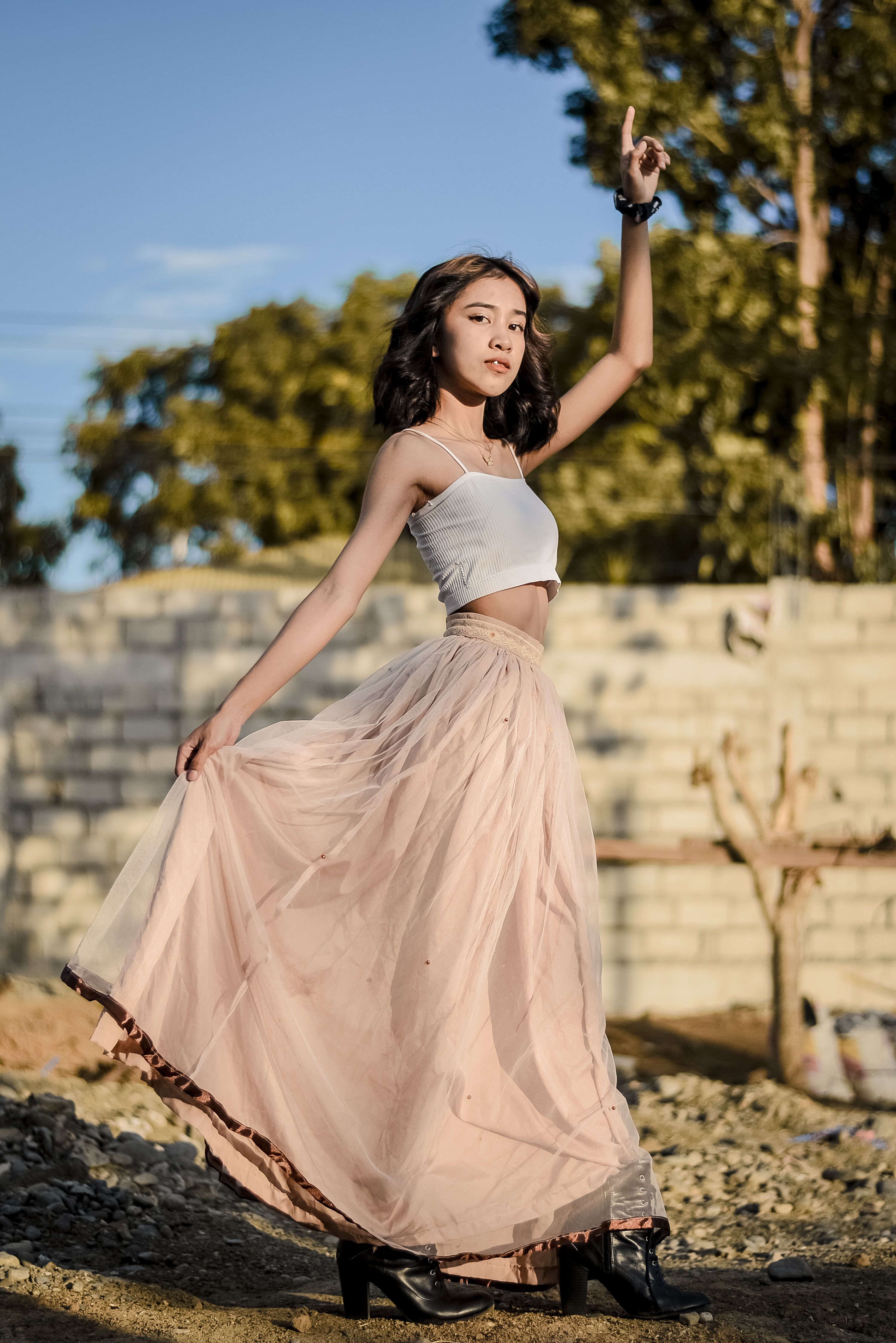 Beautiful Woman in a Long Skirt with her Arm Raised · Free Stock Photo