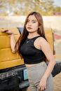 Woman in Black Tank Top Holding a Car Trunk