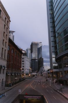 A quiet street in Vancouver's downtown with modern skyscrapers, captured on a serene daytime.
