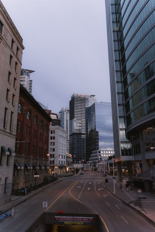 Free A quiet street in Vancouver's downtown with modern skyscrapers, captured on a serene daytime. Stock Photo