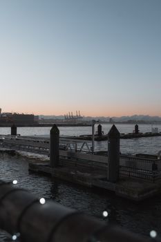 Serene sunset view over Vancouver Harbor showcasing calm waters and distant cityscape.