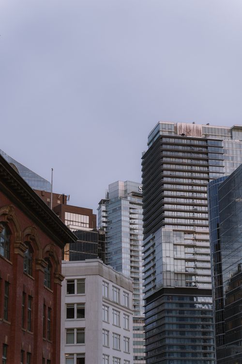 Free Skyscrapers in Vancouver showcasing modern urban architecture against a clear sky. Stock Photo