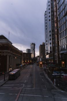 A serene view of downtown Vancouver's high-rises and street scene at dusk, capturing urban tranquility.