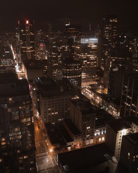 A breathtaking aerial view of Vancouver's illuminated skyline at night.