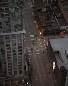 High-angle cityscape view of downtown Vancouver street in the late afternoon.