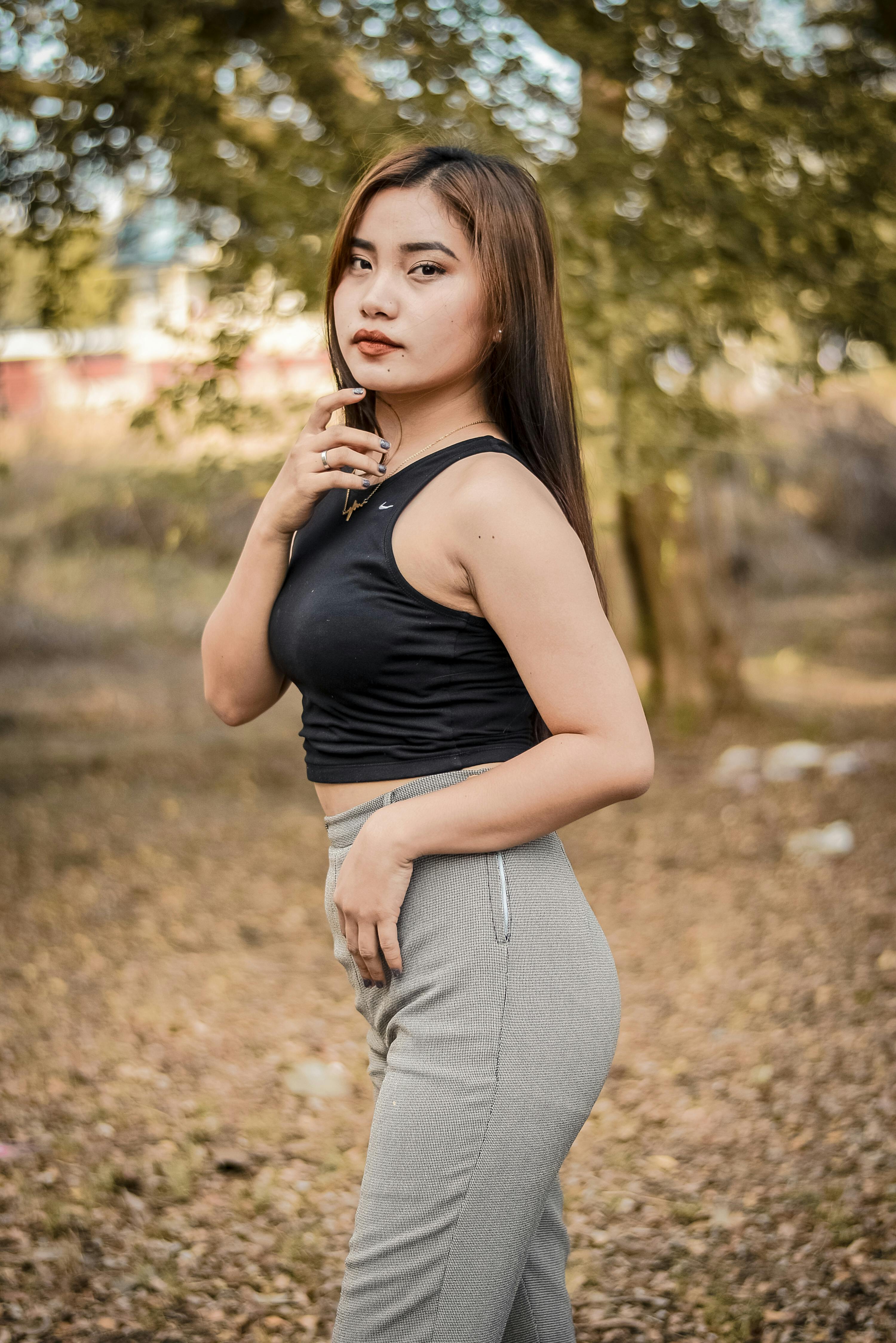 Woman in Black Tank Top and Gray Pants Posing · Free Stock Photo